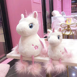 Two plush unicorn toys.