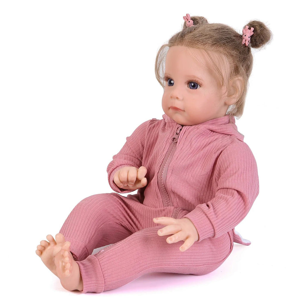 Maggi 58cm Reborn Doll handcrafted in realistic silicone wearing a pink dress for cuddling, display, and pretend play.