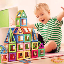 Magnetic Building Blocks, child playing with colorful magnetic building blocks on a table, for gifting to preschoolers and toddlers.