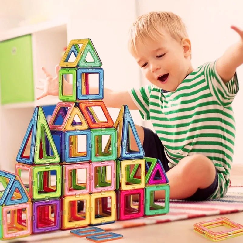 Magnetic Building Blocks, child playing with colorful magnetic building blocks on a table, for gifting to preschoolers and toddlers.