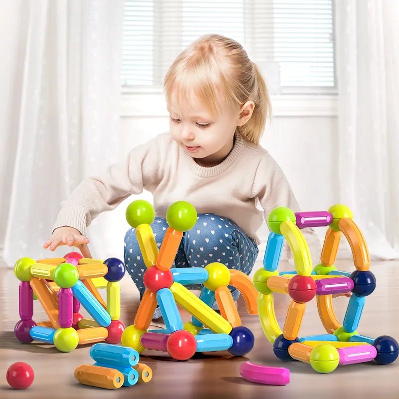 Child playing with colorful magnetic building blocks.