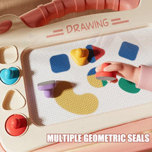 Close-up of a child's hand pressing geometric stamps on a magnetic drawing board