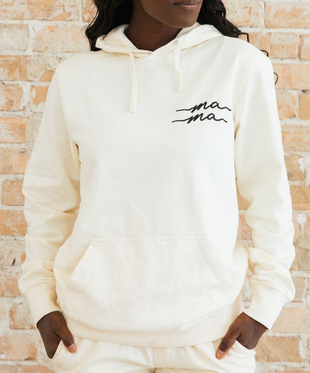 Person wearing a white hoodie with 'ma ma' text.