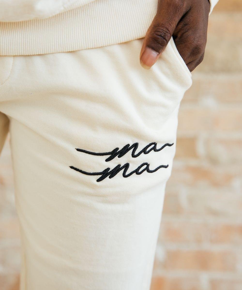 White pants with 'ma ma' embroidery.