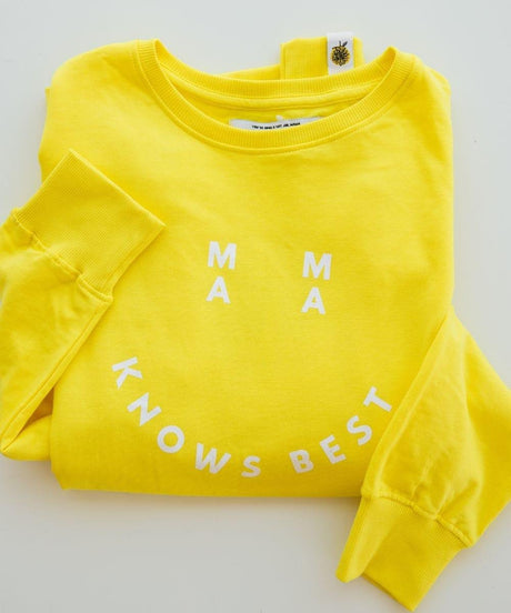 Yellow sweatshirt with 'MAMA KNOWS BEST' text on a light gray background