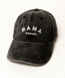 Black cap with 'MAMA KNOWS' text 