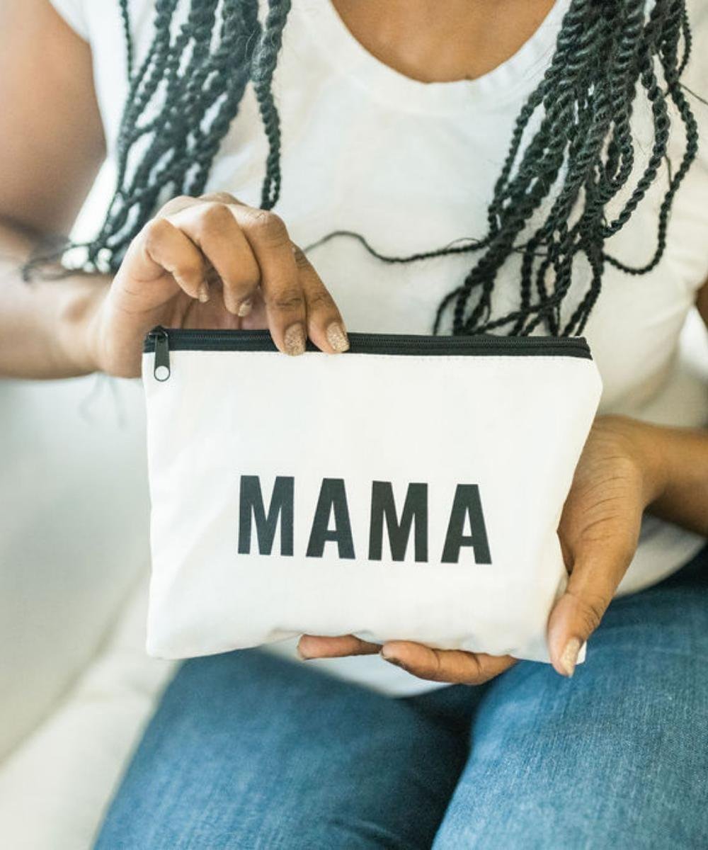 Mama Pouch minimalist zipper pouch held by hand for on-the-go mom essentials and everyday carry.