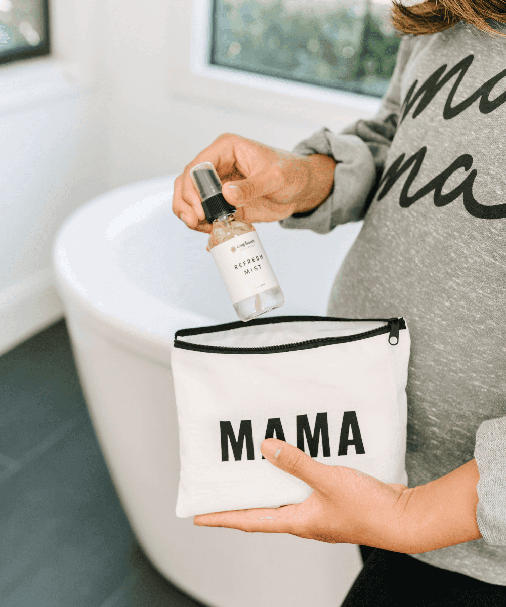 Mama zipper pouch self-care set held in hand for carrying skincare essentials in a handbag or hospital bag.