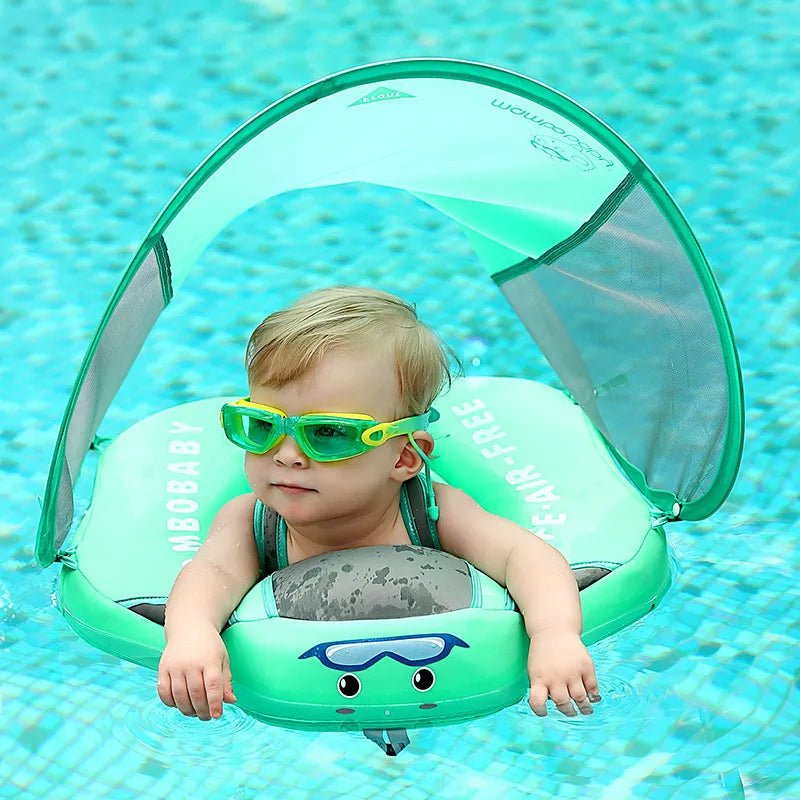 Baby using the Mambobaby green swim ring with canopy for safe splashing during pool outings.