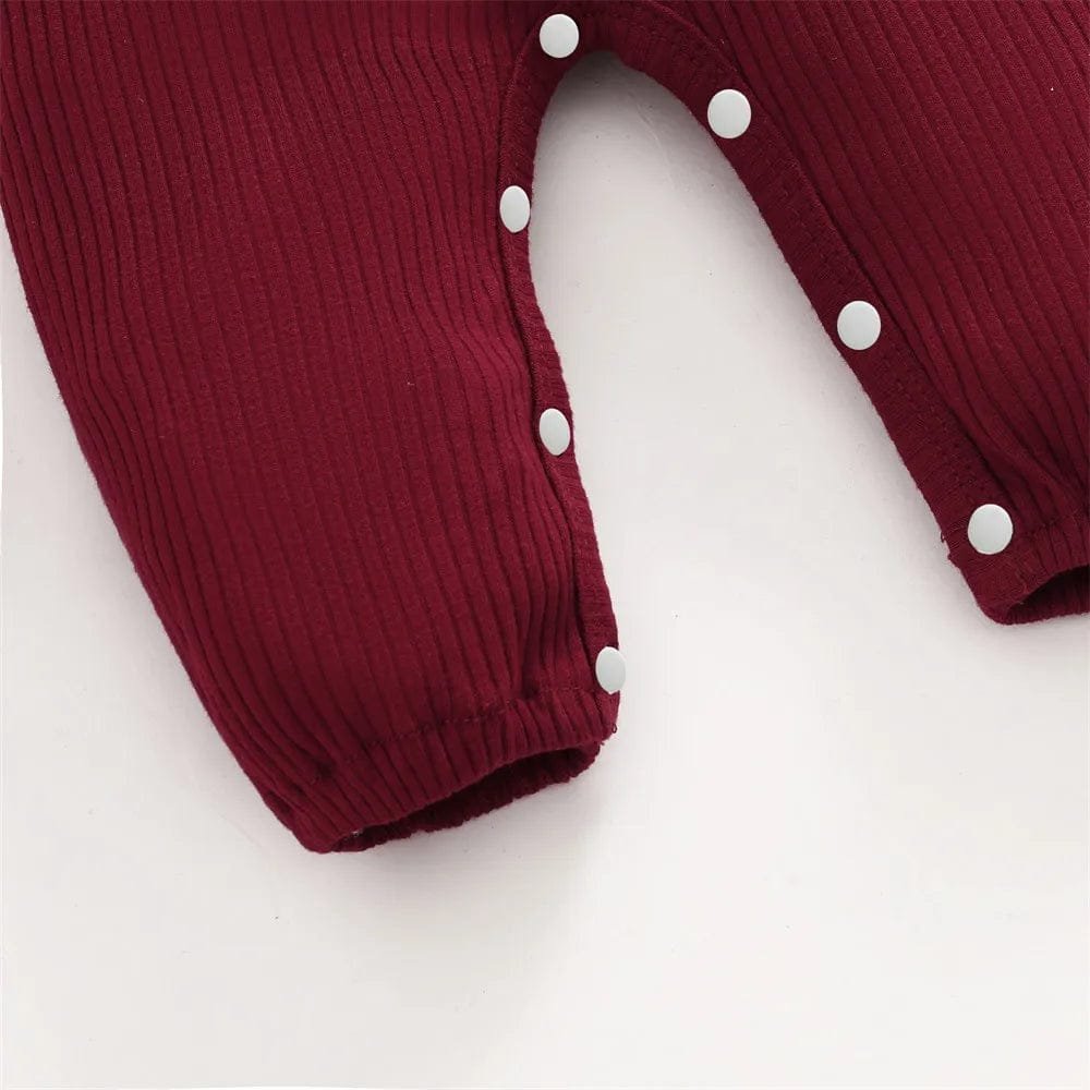 Maroon long-sleeve baby girl romper with white buttons for cosy everyday wear and nursery days.