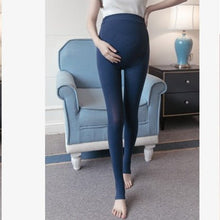 Maternity belly legging in blue worn standing to showcase autumn pregnancy tights fit.