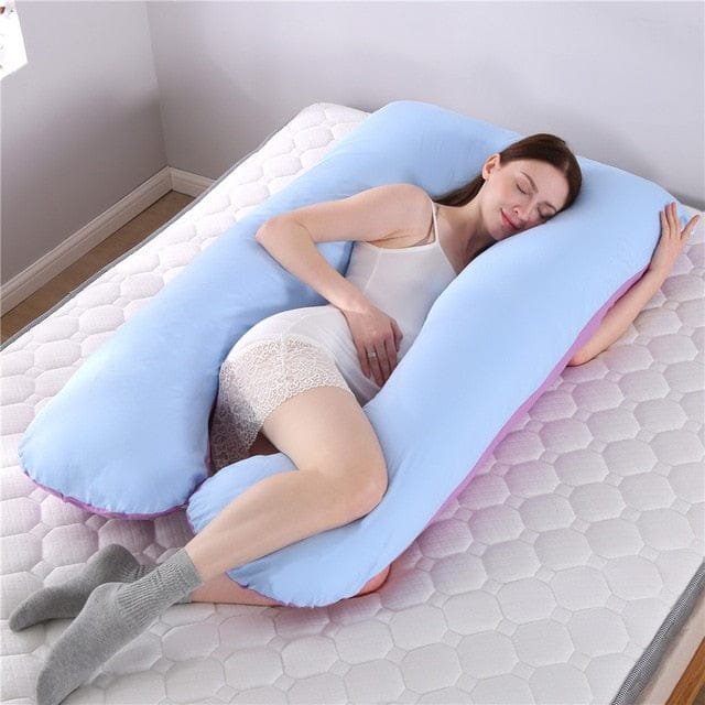 Maternity U pillow supporting a full night of rest with cushioned head, bump, and leg positioning.