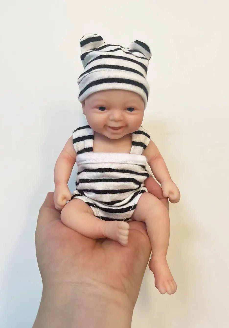 Micro Preemie reborn baby doll Noah in a zebra-print outfit and hat for doll collecting, gifting, and gentle pretend play.
