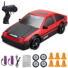Red and black toy car with remote control, batteries, and accessories.