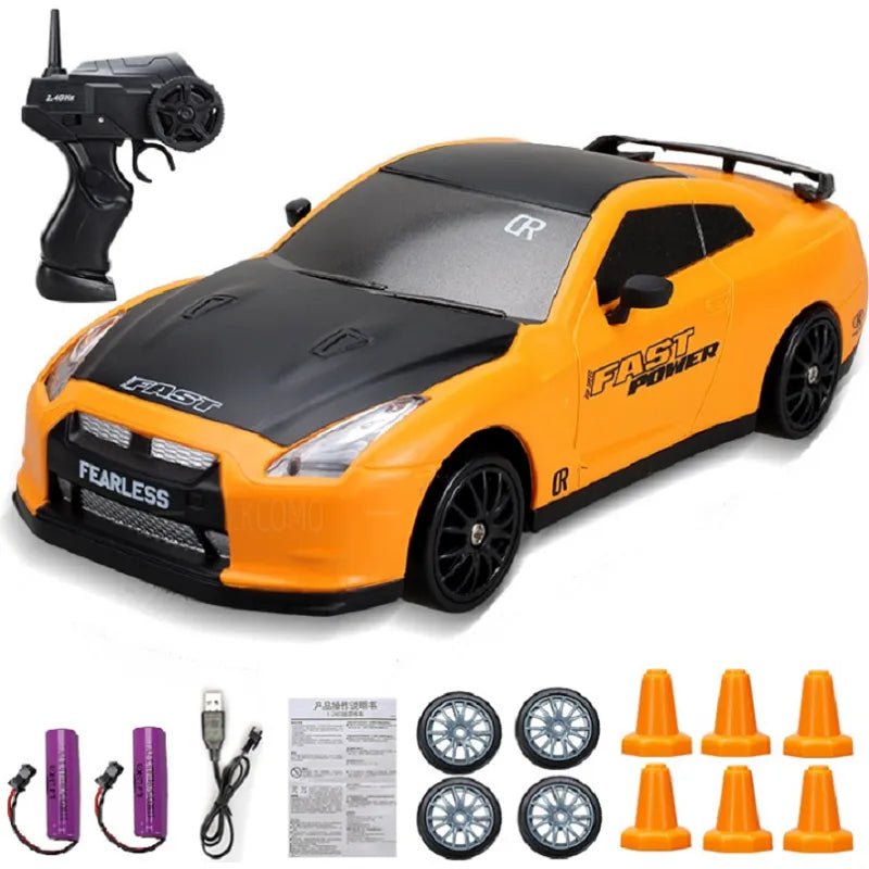 Orange and black toy car with remote control, batteries, and accessories