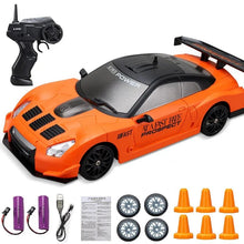 Orange toy car with remote control, batteries, and accessories