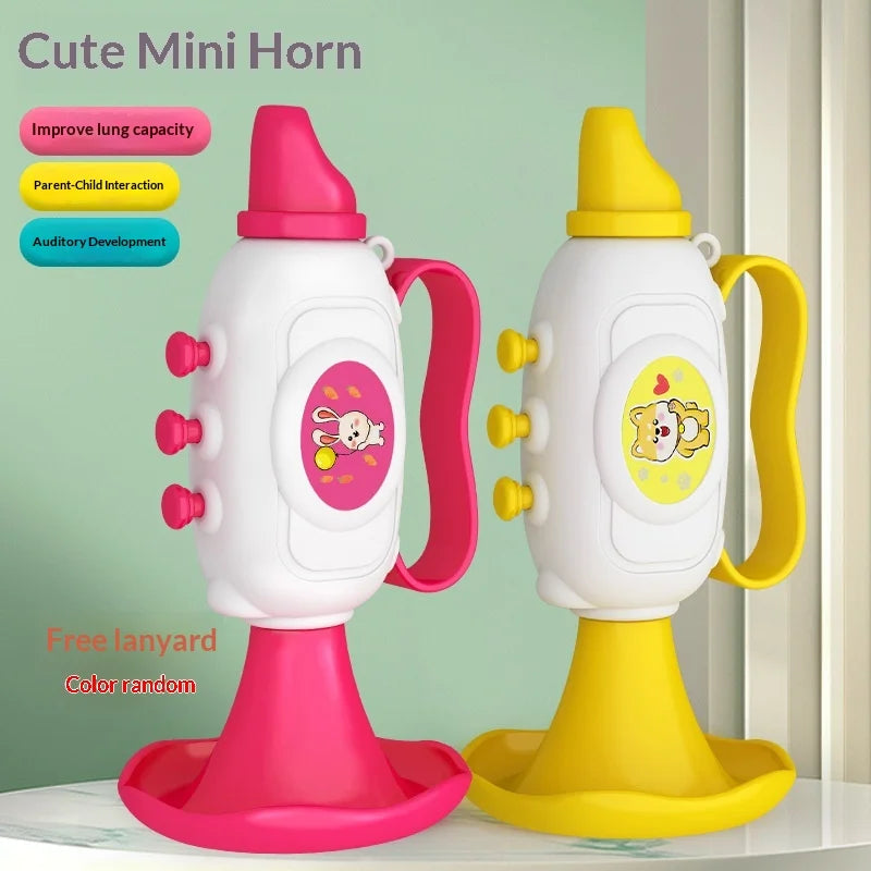Pink and yellow mini horn toys standing on their bells with a note about a free lanyard in a random color