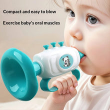 Baby blowing a teal mini horn toy with a panda picture and a loop handle