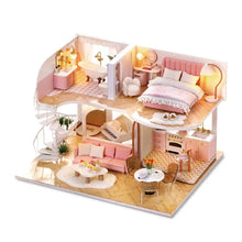 DIY wooden mini dollhouse assembly kit with pink interior furniture ready for step-by-step building.