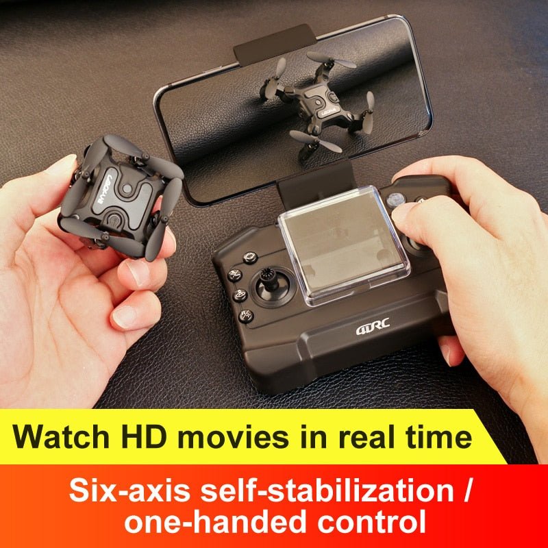 Mini RC drone held alongside its remote controller ready for indoor and outdoor flying.