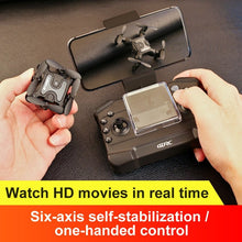 Mini RC drone held alongside its remote controller ready for indoor and outdoor flying.