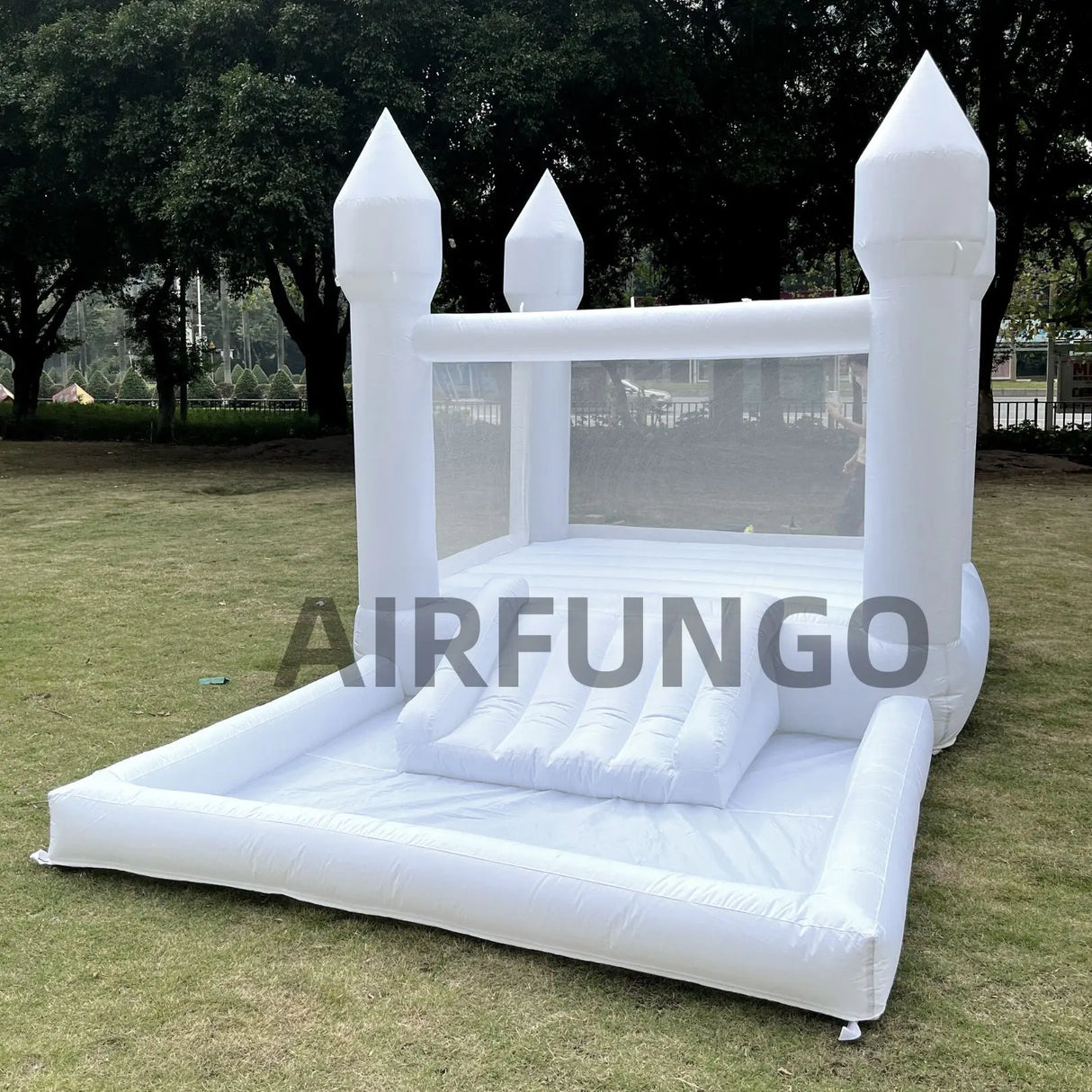 White inflatable bounce house with castle design on grass, branded 'AIRFUNGO'.