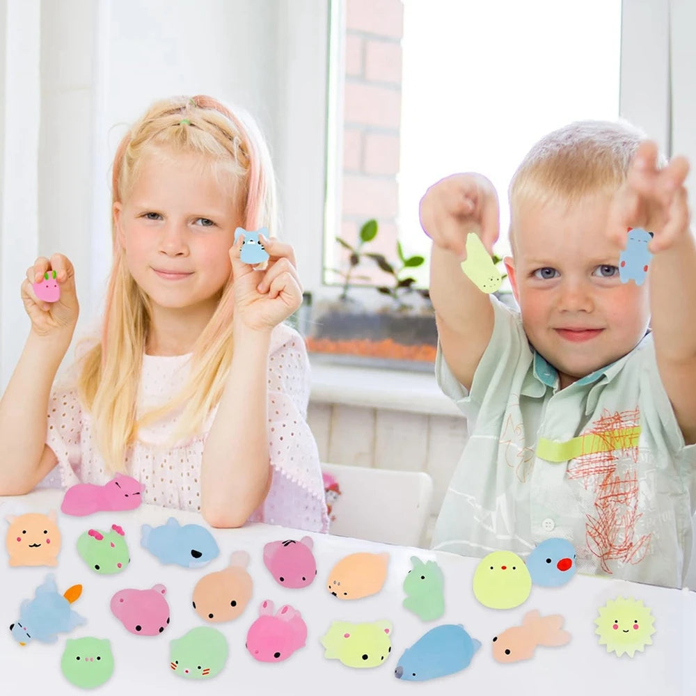 Two children playing with colorful animal-shaped erasers on a table.