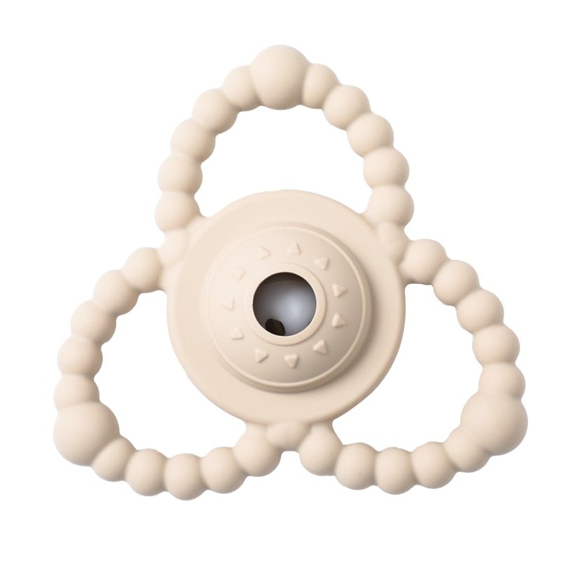 Beige teething ring with a central round design.