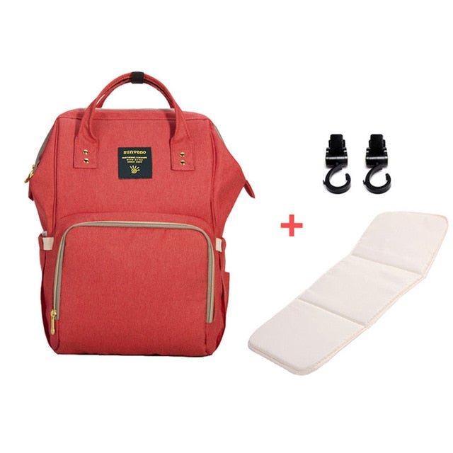 Red backpack with a white mat and black clips.