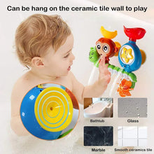 Child playing with the monkey caterpillar bath toy mounted on the shower wall for interactive fun.