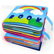 Montessori busy board cloth book with a rainbow and cloud design for calm sensory play and nursery reading time.