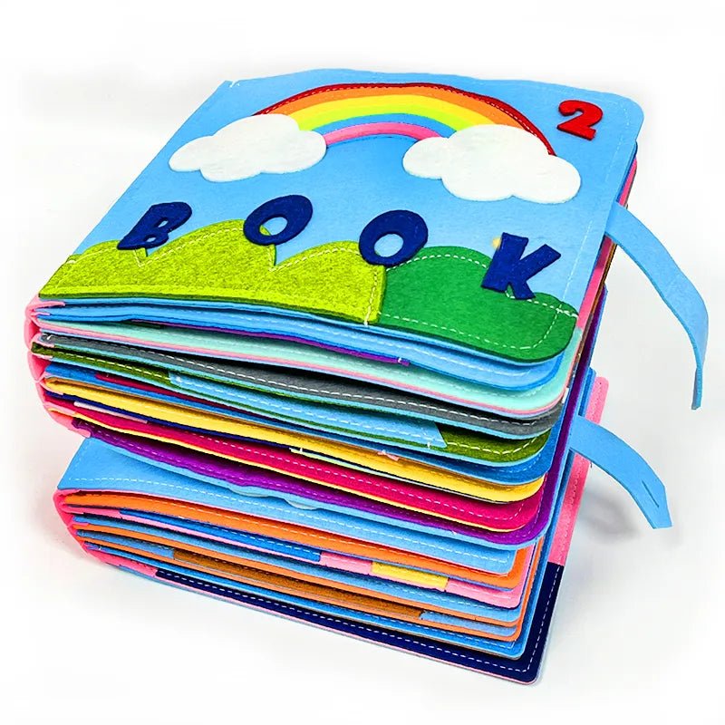 Montessori busy board cloth book with a rainbow and cloud design for calm sensory play and nursery reading time.
