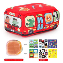 Red bus-shaped Montessori Magic Tissue Box with animal illustrations and pull scarves for baby sensory play.