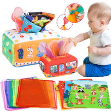 Baby playing with colorful educational toys and cloth books.