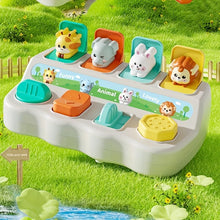 Montessori pop-up animal toy on a grass and pond background, second view