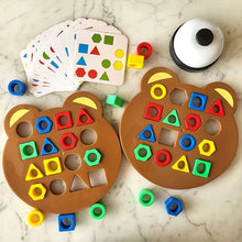 Two bear-shaped educational toys with colorful geometric shapes.