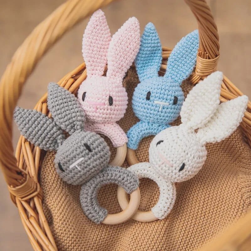 Multicolour wooden baby rattle and teether set with crochet animal heads, soft toys for newborn gifting and sensory play.
