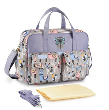 Multifunctional Waterproof Diaper Bag with patterned finish and matching accessory pouches for storing wipes, nappies, and feeding supplies.
