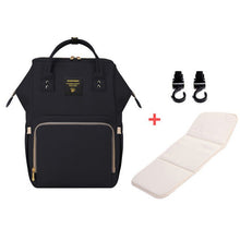 Black backpack with a white mat and two black hooks.
