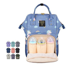 Blue diaper bag with bottle compartments and cloud pattern.