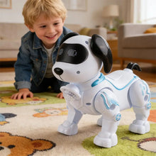 Smiling boy kneeling on a play mat beside a white robot dog with black ears and a blue light strip