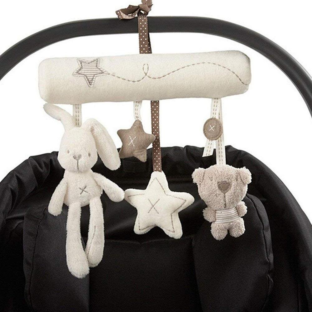 Musical hanging bell toy attached to a baby stroller for on-the-go soothing during walks.