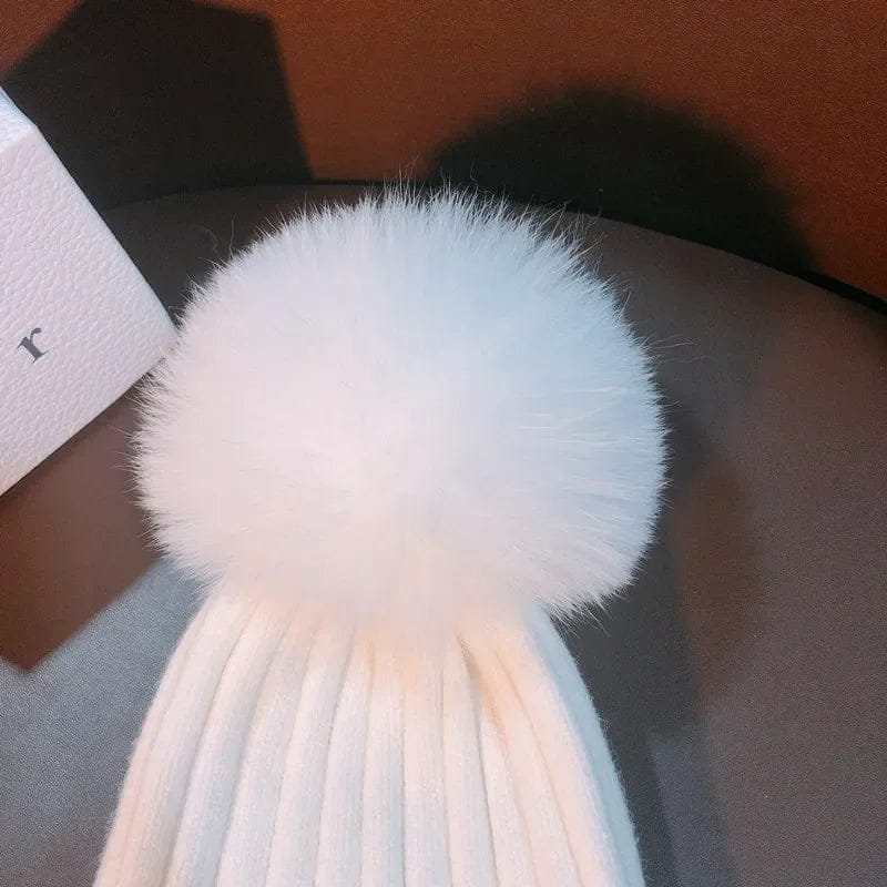 Close-up of the natural mink fur pom pom topper that finishes this kids knitted winter beanie.