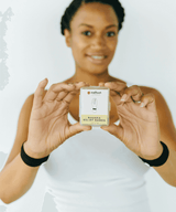 Woman holding a box of 'Natura Relief Bands'.