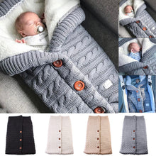 Newborn knitted sleeping bag worn by a baby with colour options for choosing a cosy sleep sack.