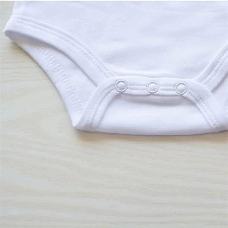 Close-up of the white newborn letter print onesie showing snap fastenings that simplify nappy changes.