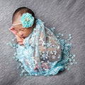 Newborn photography prop set with blue lace wrap and headband for baby photo shoots and keepsake portraits.