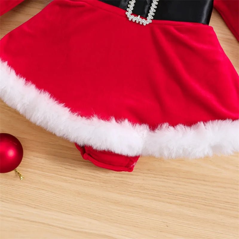 Newborn Santa velvet romper outfit laid flat with fur trim for first Christmas keepsake photos and family gatherings.