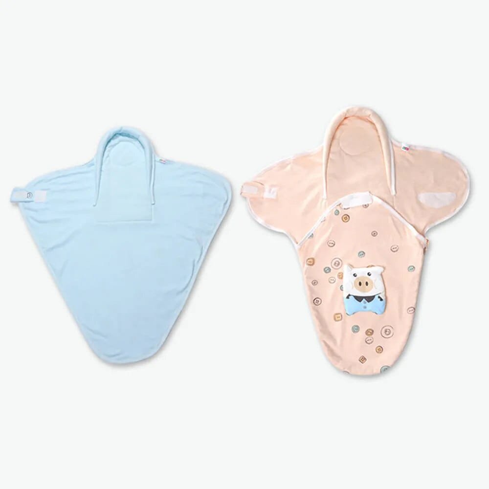 Newborn sleep sack in blue and pink cartoon prints for choosing a swaddle style for boys or girls.