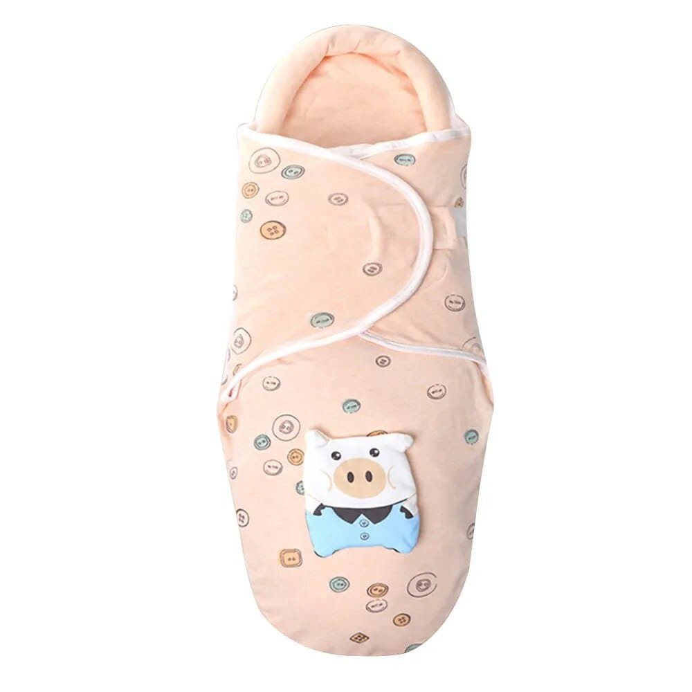 Newborn sleep sack in a cartoon print, styled as a cosy blanket alternative for safer cot sleeping.